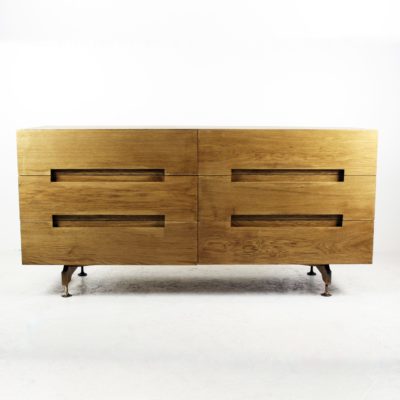 Six drawer chest of drawers, oak veneer, brass legs.