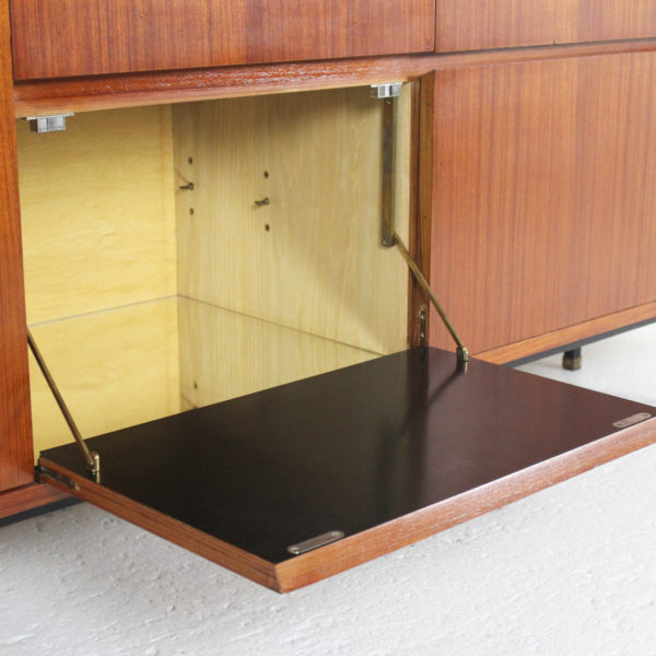 Long vintage design enfilade, in teak veneer, black lacquered metal and brass base, made by Paul Geoffroy in the 60s.