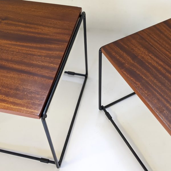 Paire de tables basses/tabourets vintage, à plateaux réversibles en acajou, coussin en mousse refaite à neuf, recouverte d'un tissu de la Maison Pierre Frey, piétement en métal laqué noir. Travail français des années 50.